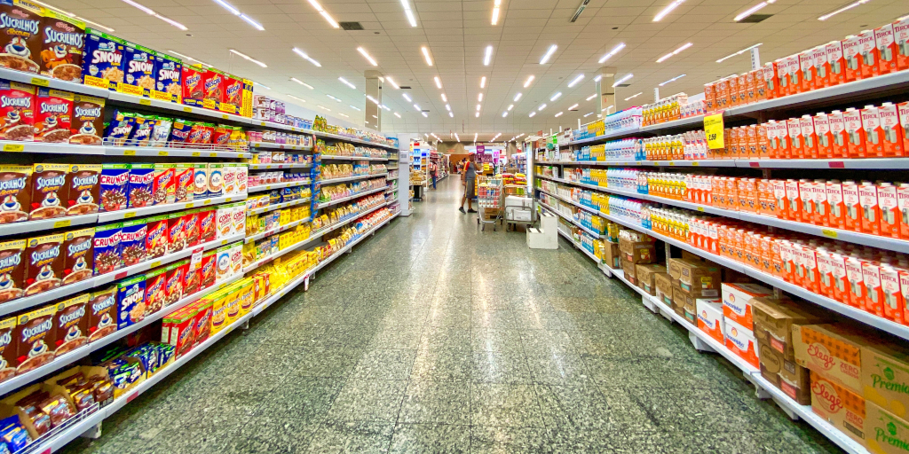Essential Manners_Photo by Nathália Rosa on Unsplash. Shows a supermarket aisle with shelves of breakfast cereal.