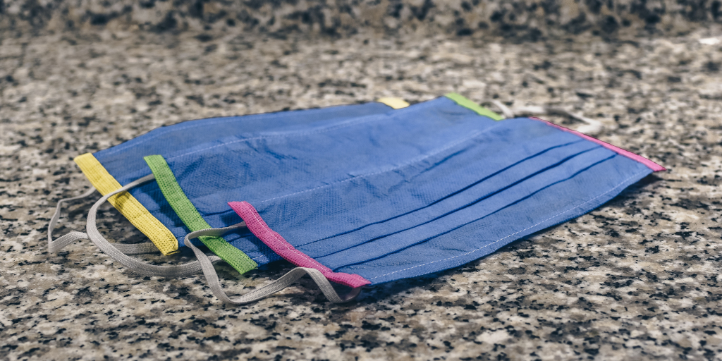 There But For The Grace. Photo by Ibrahim Boran on Unsplash. Shows a heap of COVID protective masks.