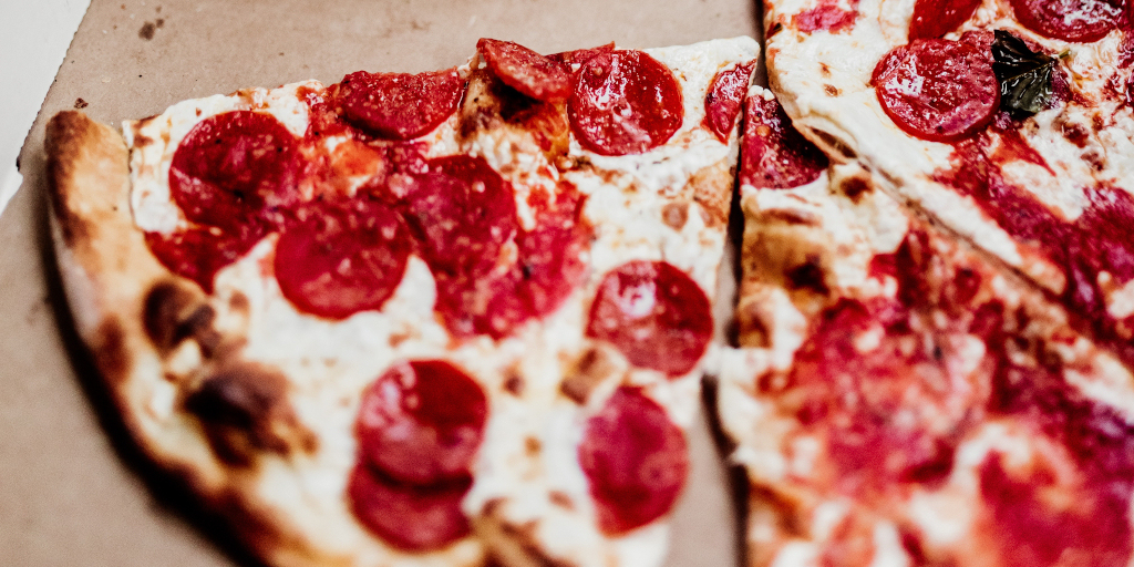 WildKit_Photo by Jordan Nix on Unsplash. Shows slices of pepperoni pizza in a cardboard box.